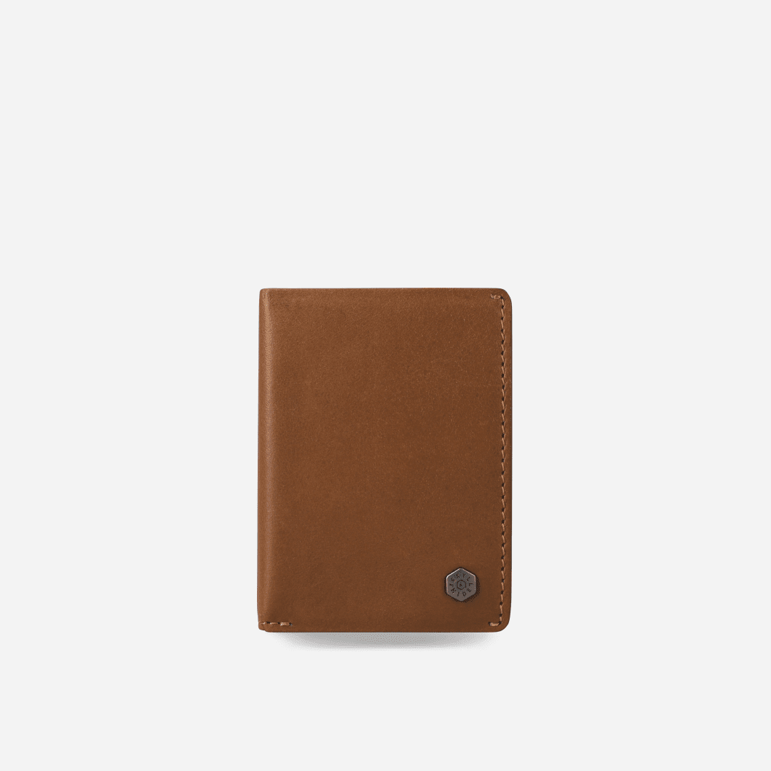Jekyll & Hide Card Holder in tan leather, front view with hexagonal metal logo badge