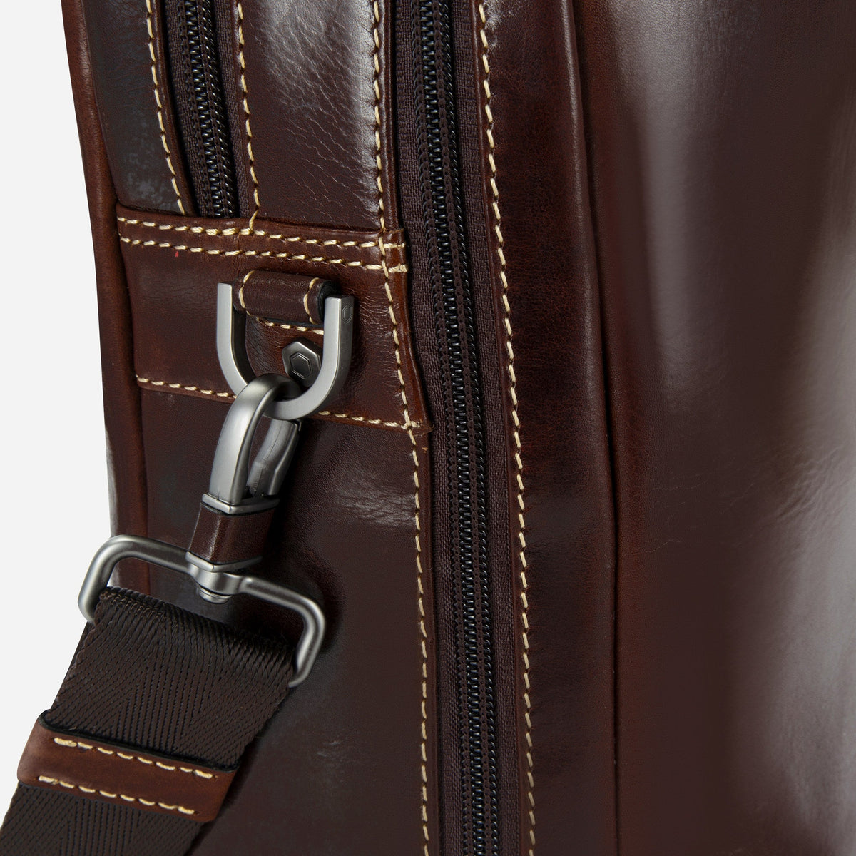 Close-up of the Mocha Laptop Briefcase's contrast stitching, zip and gunmetal strap clip