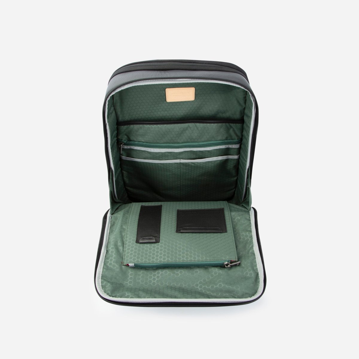 Black leather expander backpack opened flat to show the green-lined compartment and organiser – Jekyll & Hide