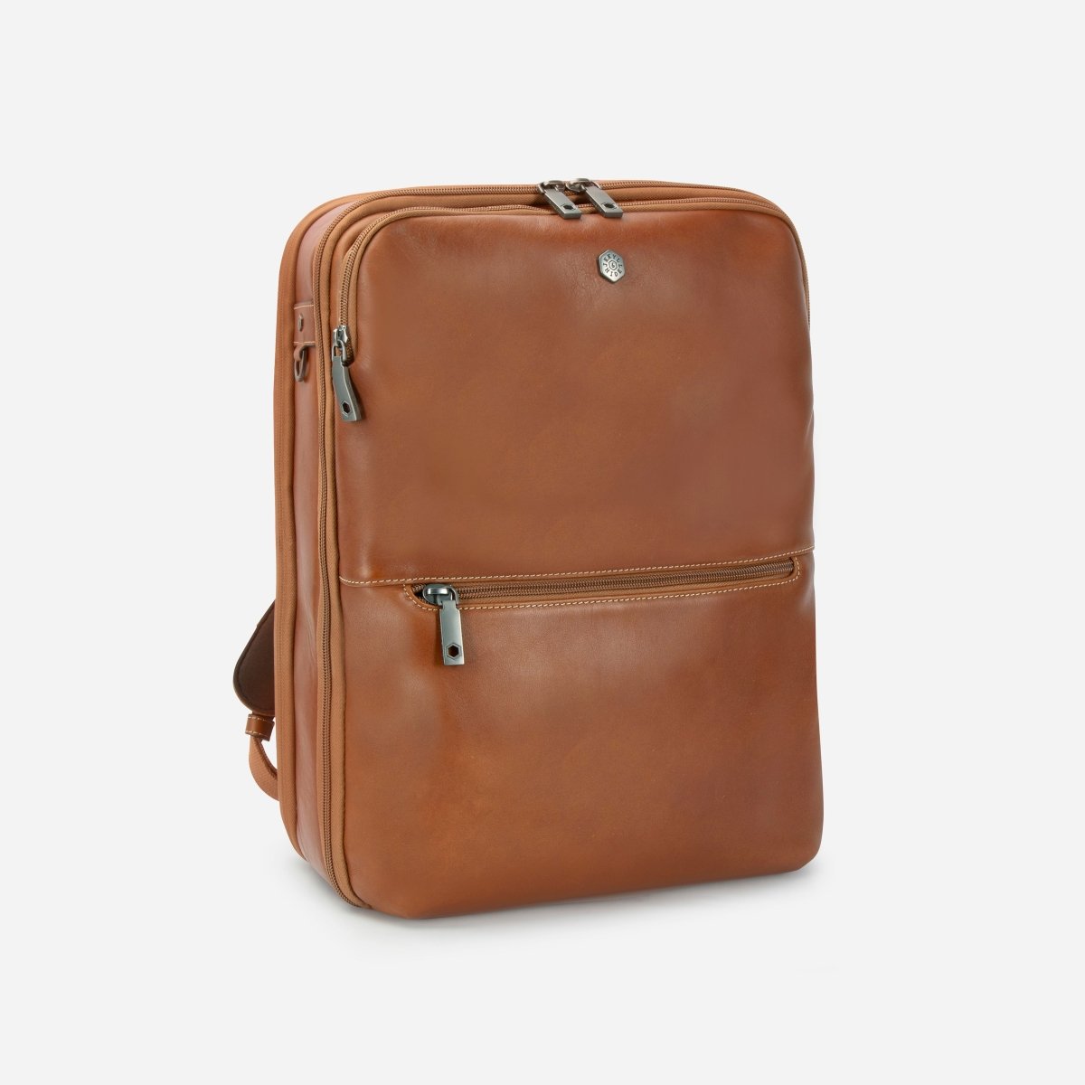 Three-quarter view of the tan leather expander backpack with side trolley strap – Jekyll & Hide