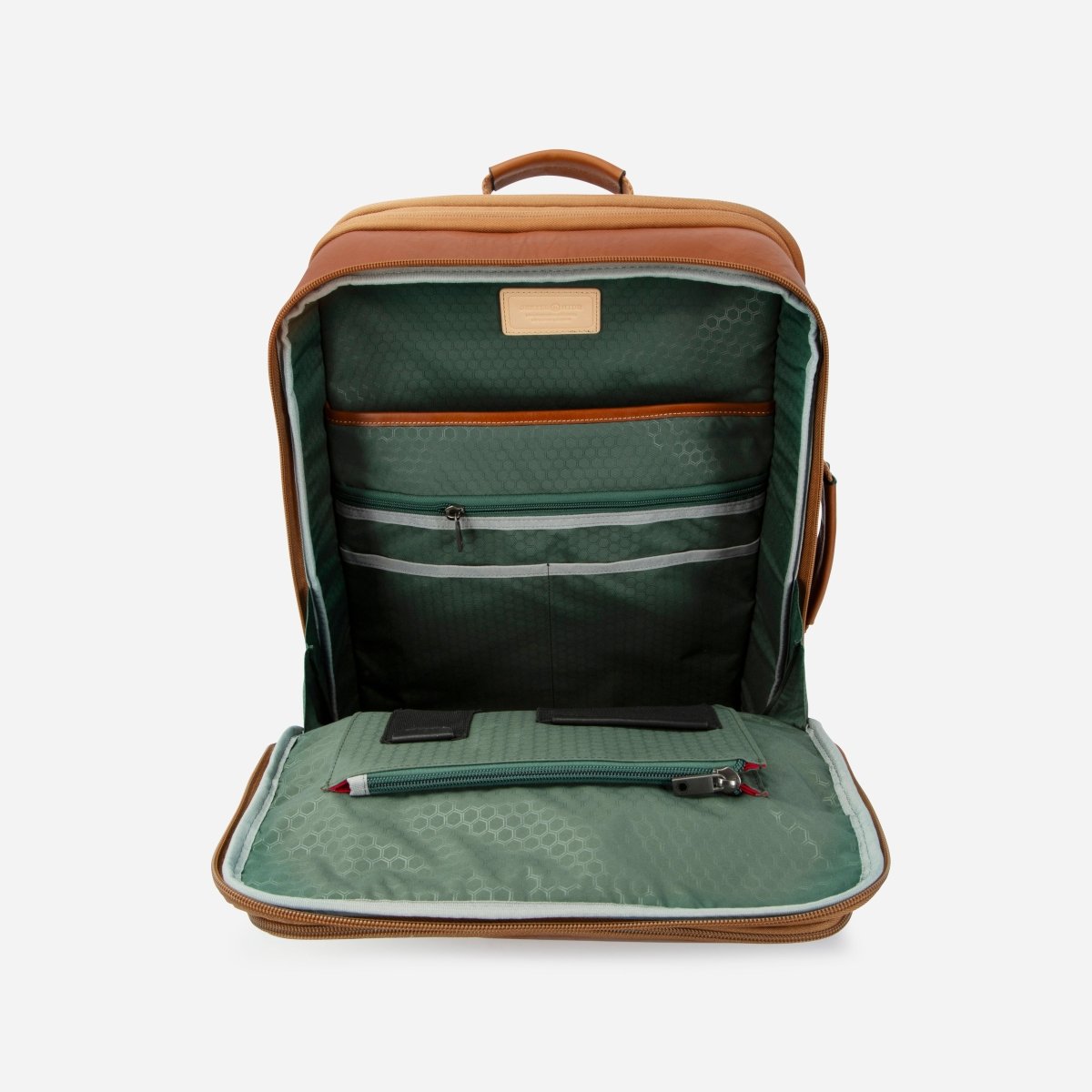 Tan leather expander backpack opened flat to show the green-lined compartment and organiser – Jekyll & Hide