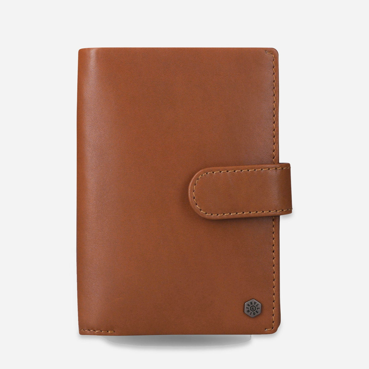 Jekyll & Hide Passport Wallet in tan leather, front view with tab closure and hexagonal logo