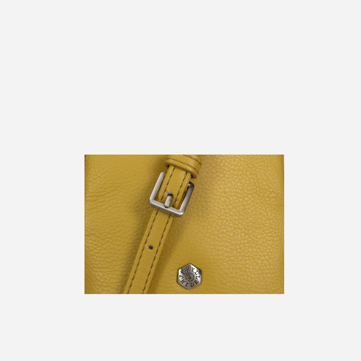 Close-up of the yellow leather Sling Bag strap buckle and press stud