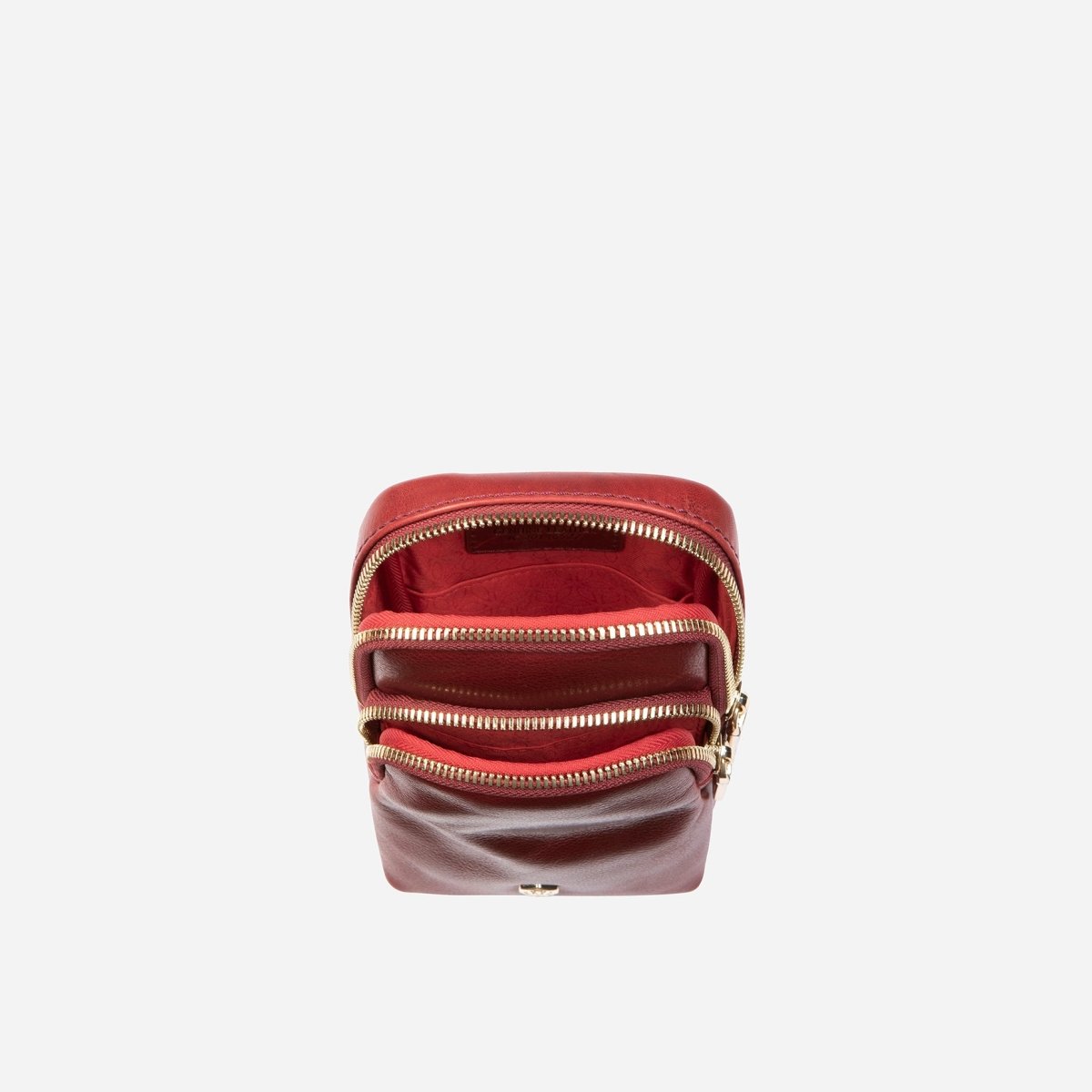 Red leather small sling bag showing the zip compartments – Jekyll & Hide