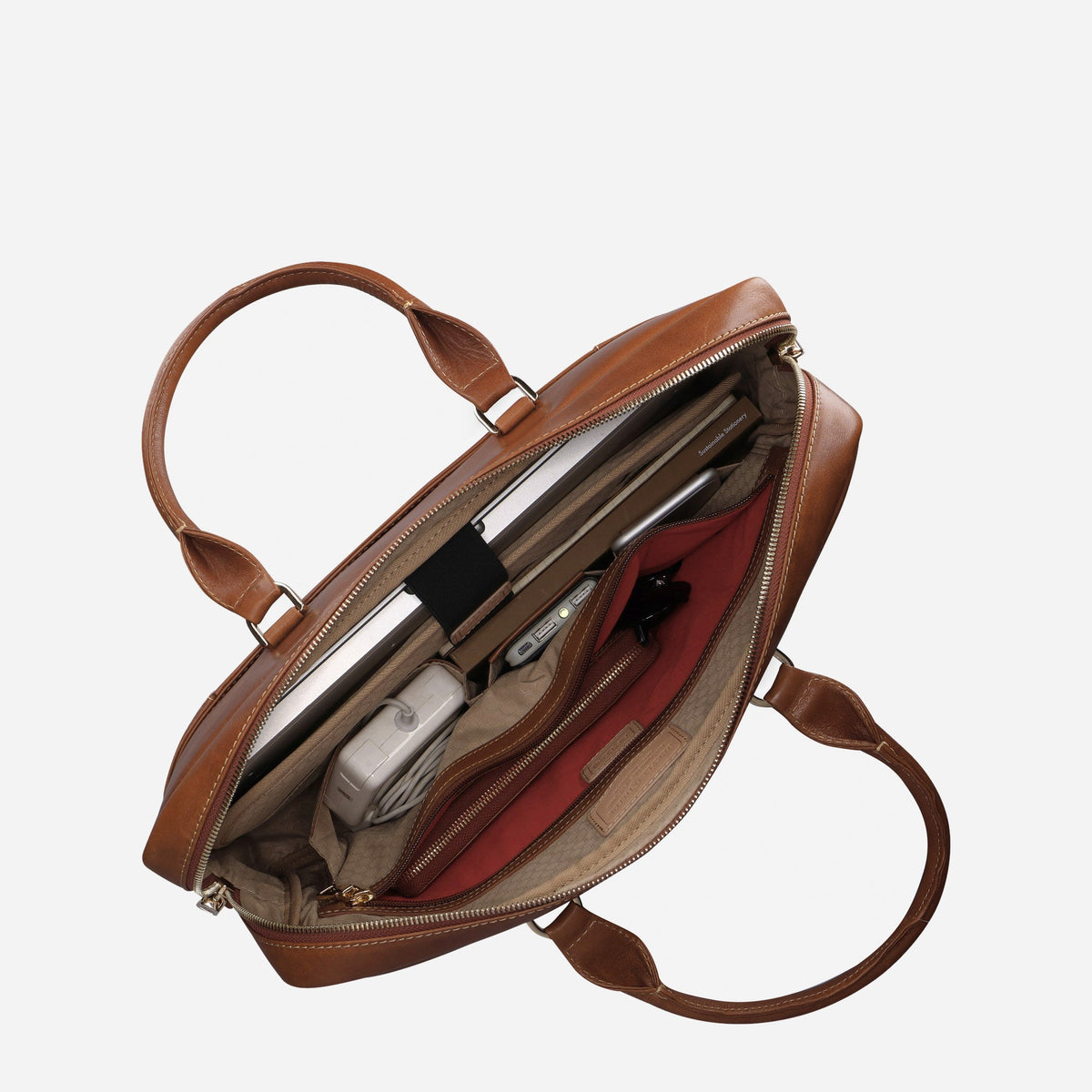 Tan leather Paris Briefcase open from above, holding a laptop, charger and accessories