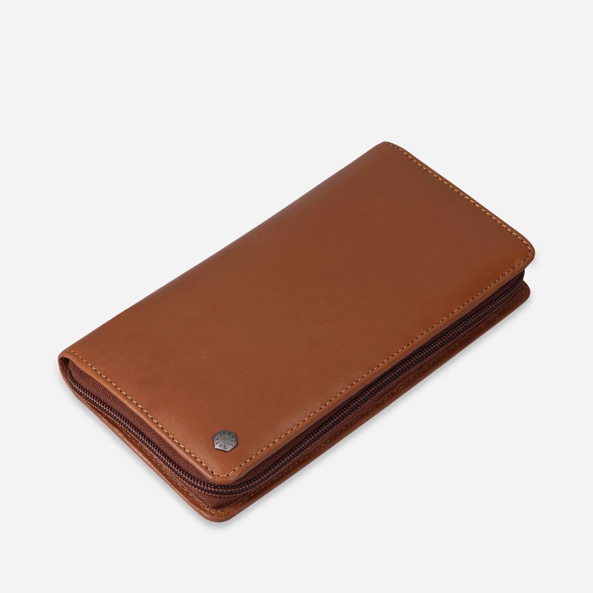 Angled view of the closed tan leather Travel Organiser with logo stud