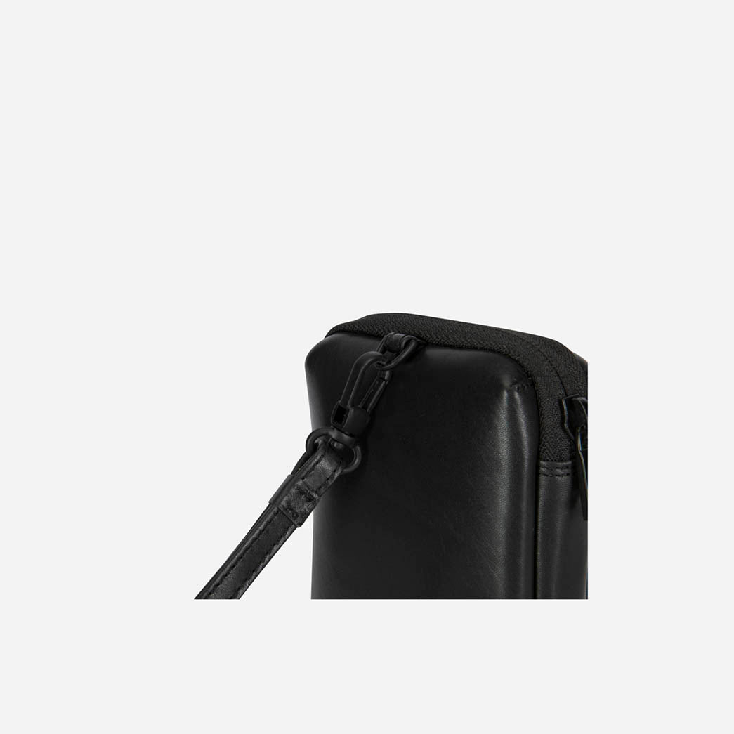 Close-up of the black Cable Pouch's zip and wrist strap loop