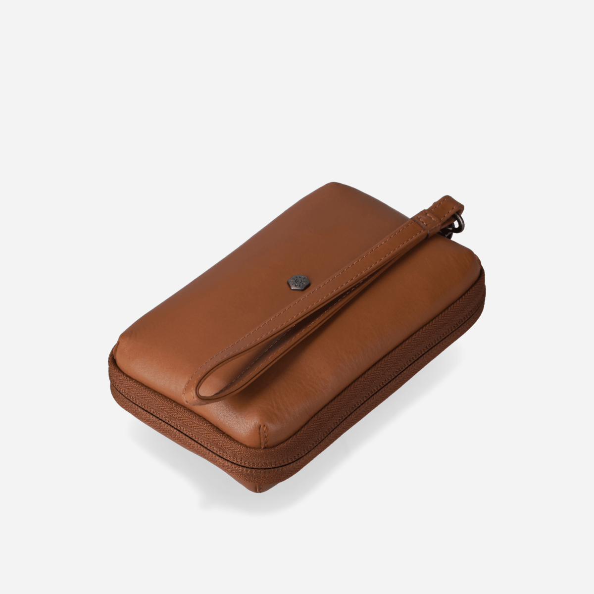 Angled view of the tan leather Cable Pouch with wrist strap
