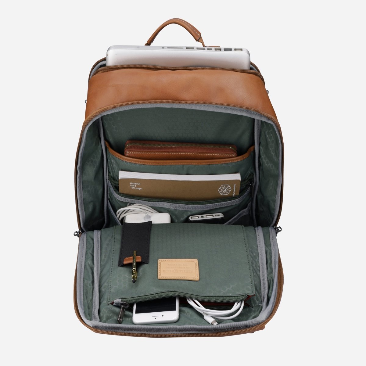 Tan leather laptop backpack opened and packed with a laptop, notebook, wallet and charger – Jekyll & Hide
