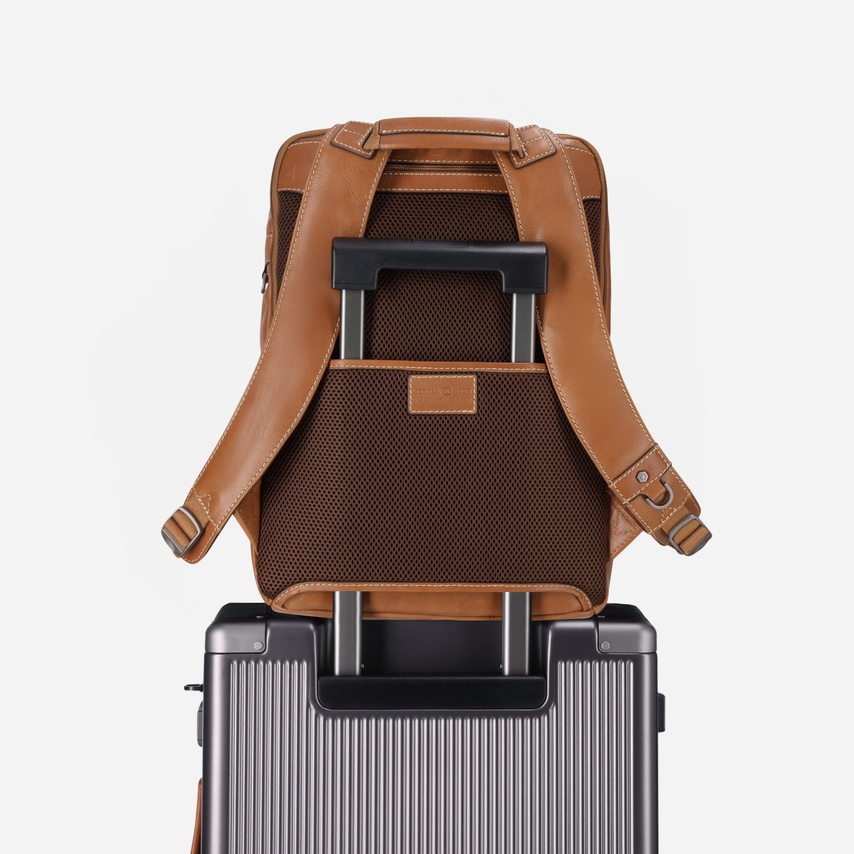 Tan leather laptop backpack slipped over a trolley case's telescopic handle – Jekyll & Hide