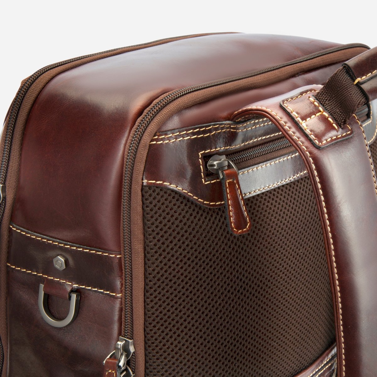 Close-up of the dark brown leather backpack's side mesh pocket and zip detail – Jekyll & Hide