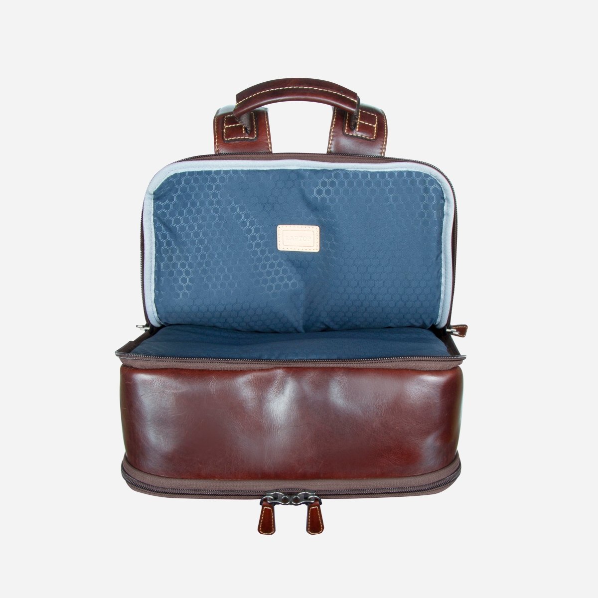 Dark brown leather laptop backpack opened to show the navy-lined front compartment – Jekyll & Hide