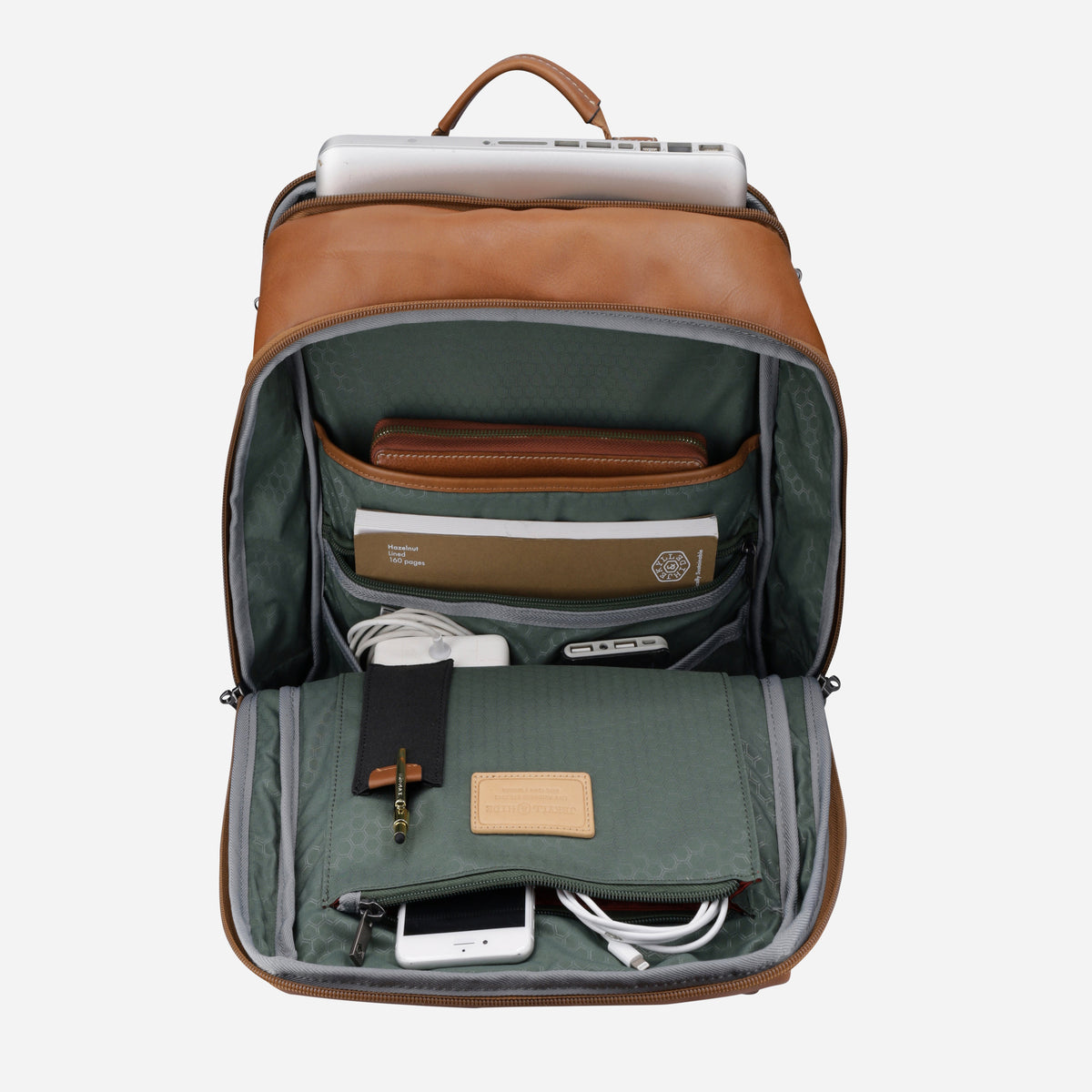 Colt Laptop Backpack opened out with a laptop, notebook and charger in its sage green organiser