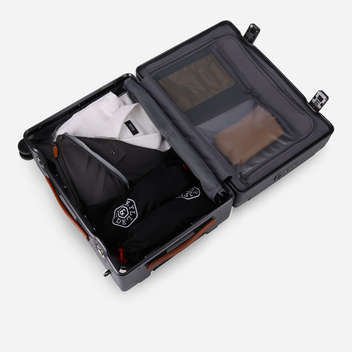 Carry-on suitcase open and packed with shirts and a Jekyll & Hide laundry pouch