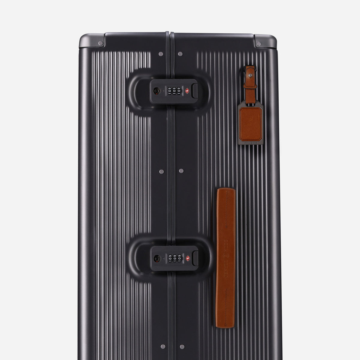 Side of the Colt Large Check-In showing twin TSA locks, tan leather handle and luggage tag