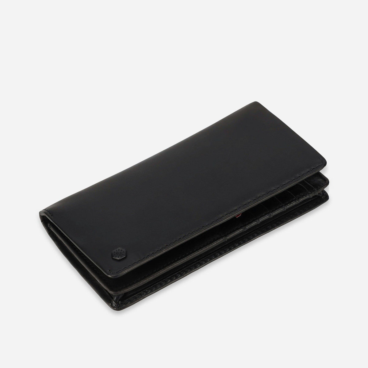 Angled view of the closed black leather Travel Wallet showing its slim profile
