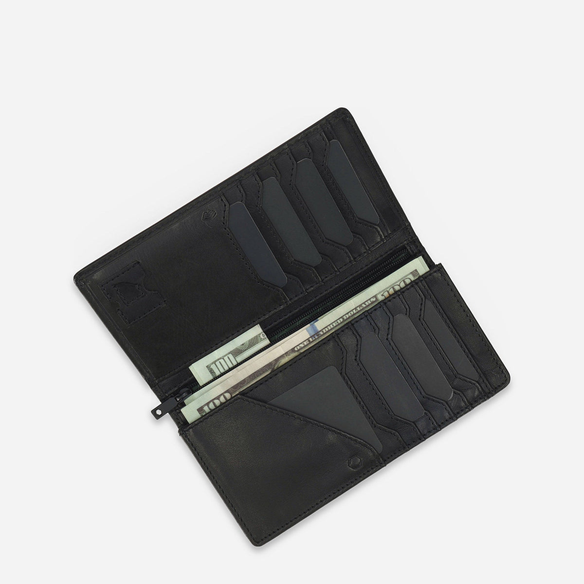 Black leather Travel Wallet open at an angle with banknotes in the zipped centre compartment