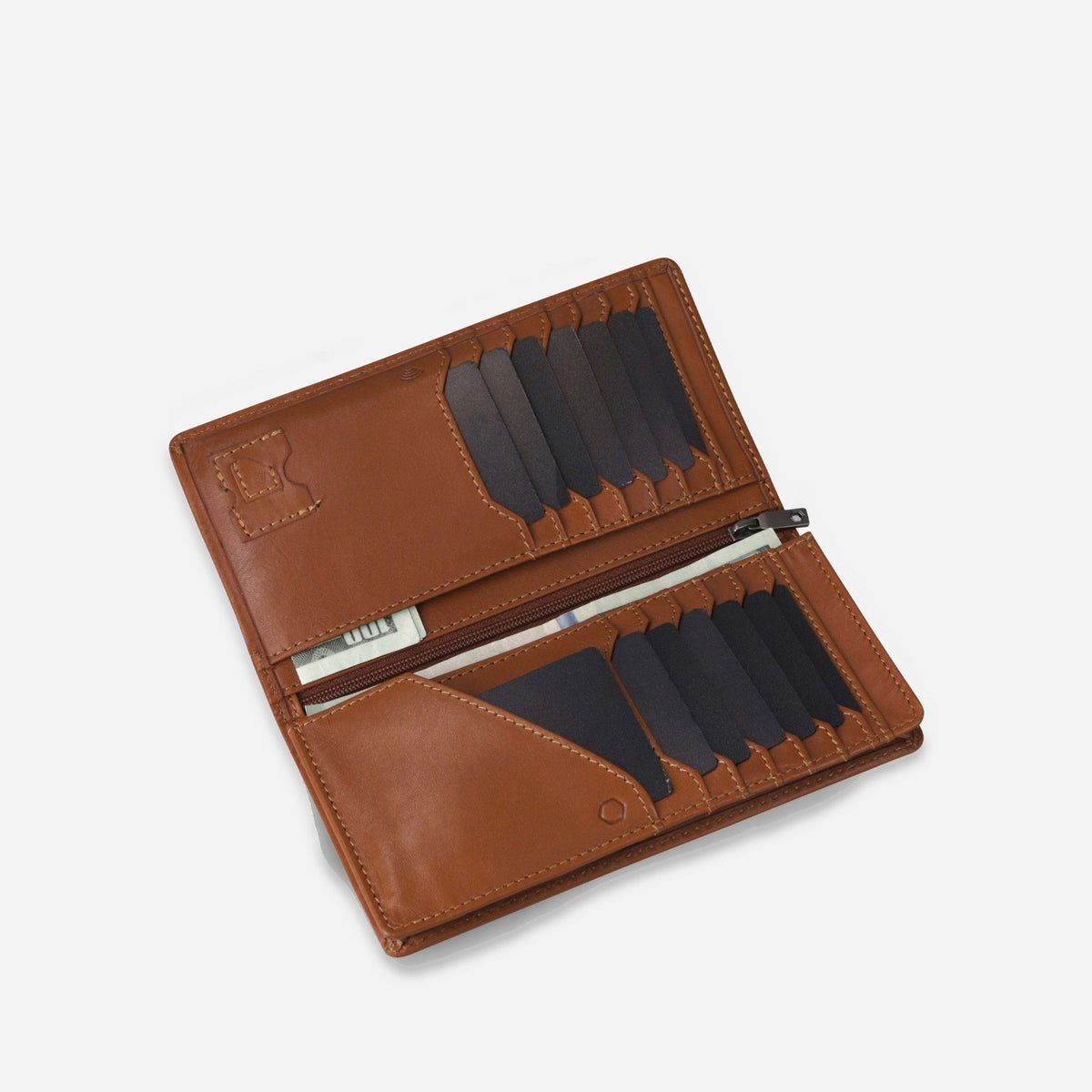 Tan leather Travel Wallet open at an angle, with notes in the zipped centre compartment