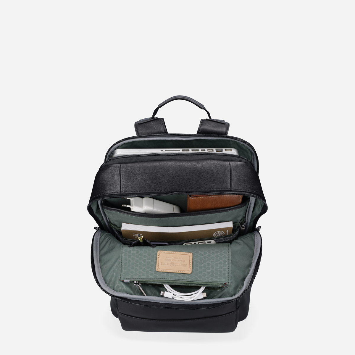 Open black leather backpack showing green organiser with laptop and tech