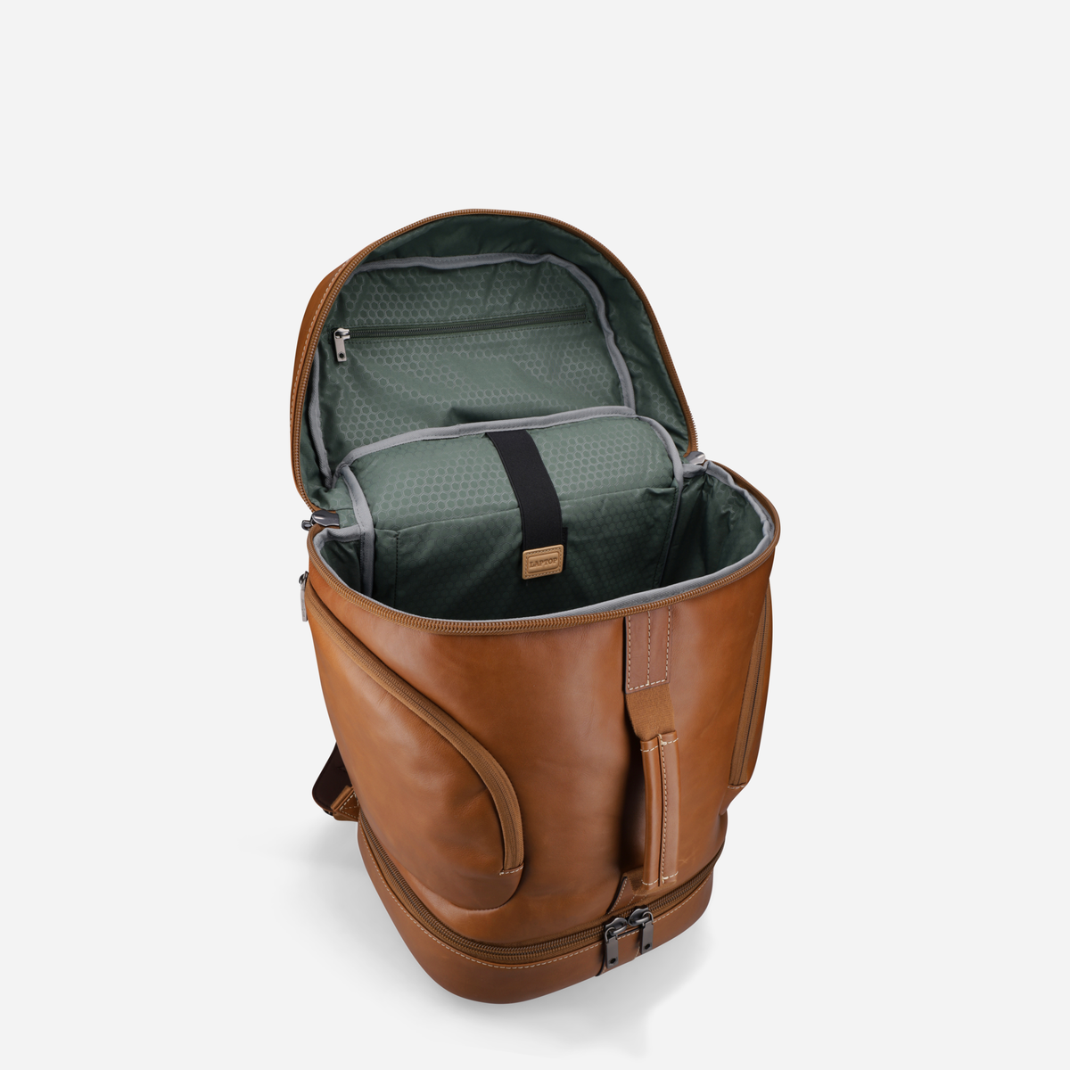 Open tan leather travel backpack showing green lining, side view