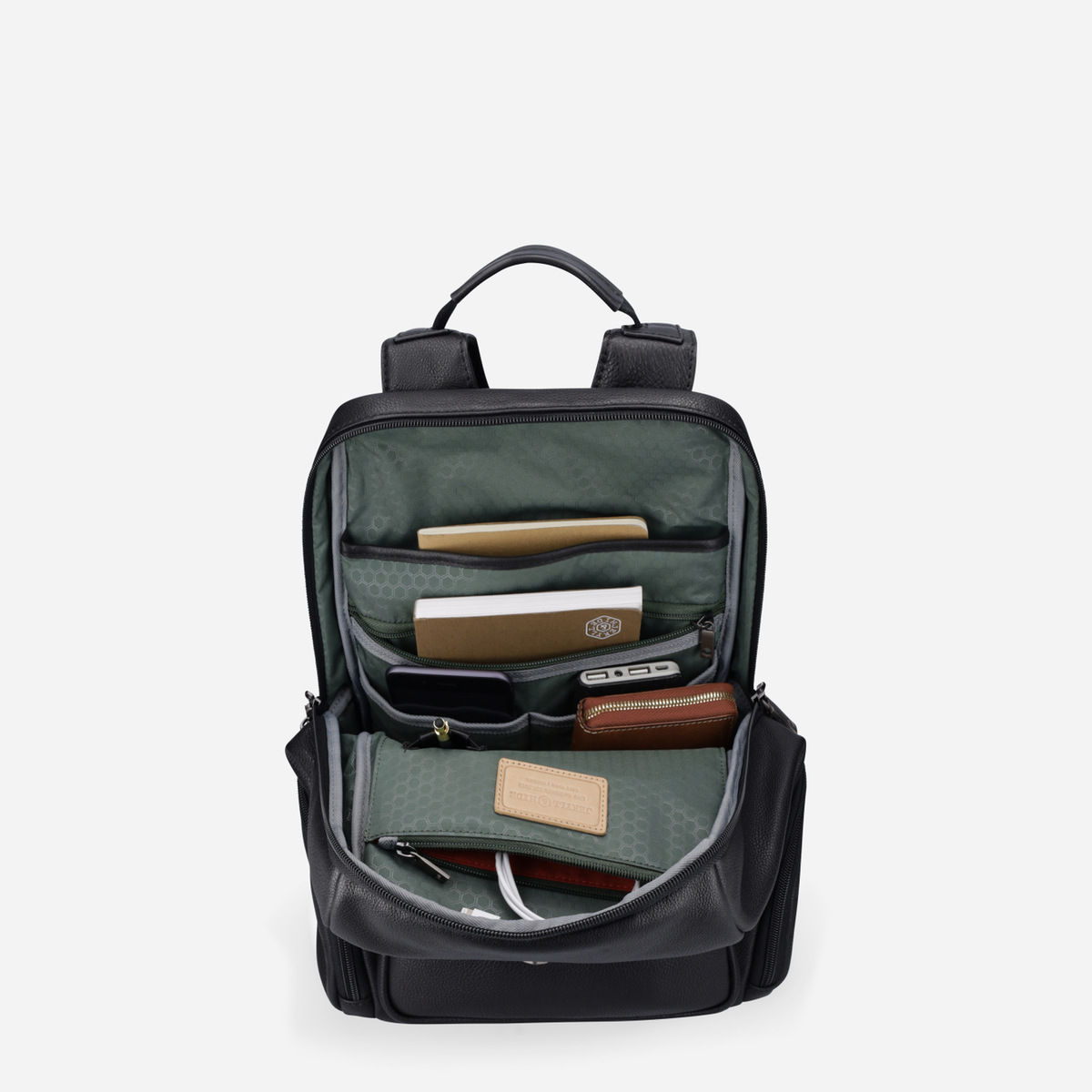 Open black leather city backpack showing green organiser and tech