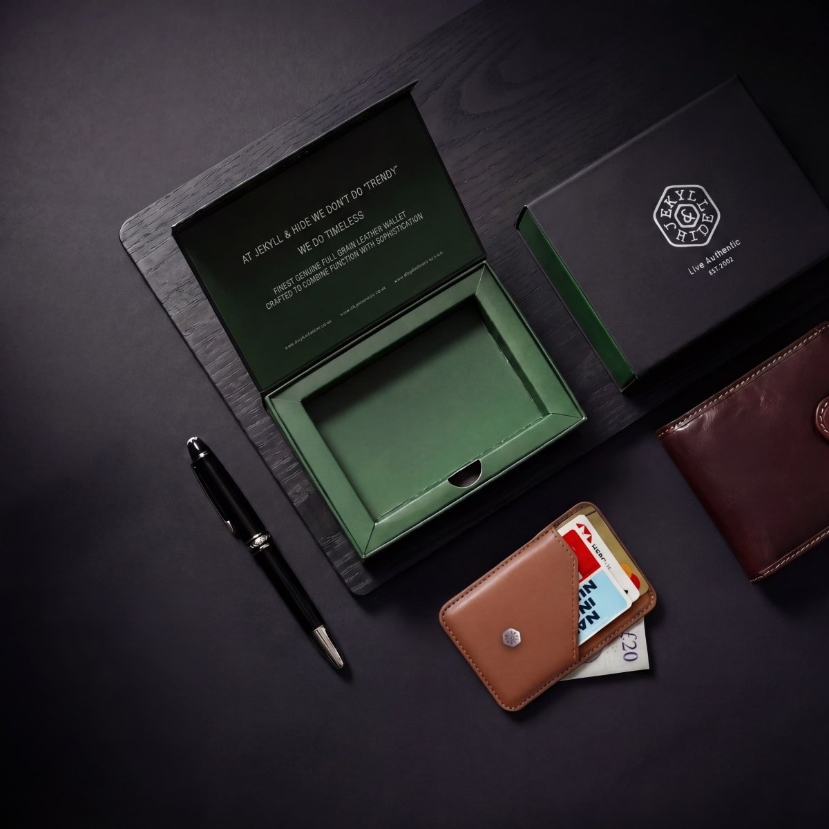 Jekyll & Hide green-lined gift box with black lid, shown with a leather wallet, card holder and pen