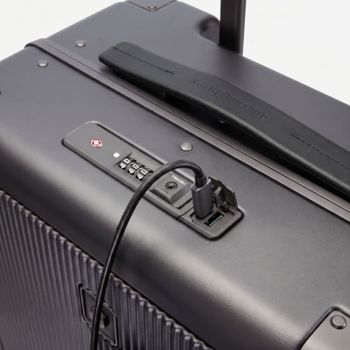 Close-up of the TSA lock and USB charging port on the Jekyll & Hide graphite-black hardshell Carry-On