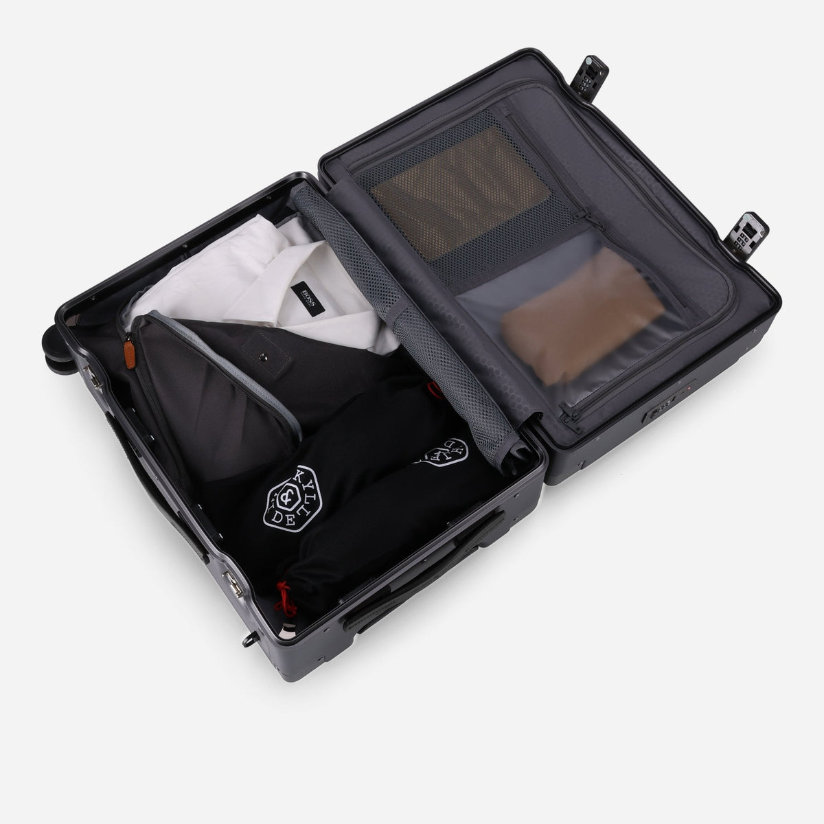 Open Jekyll & Hide graphite-black hardshell Carry-On showing packed clothing and divider