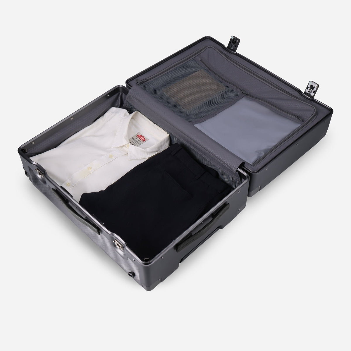Open Jekyll & Hide graphite-black hardshell Medium Check-In suitcase packed with clothing